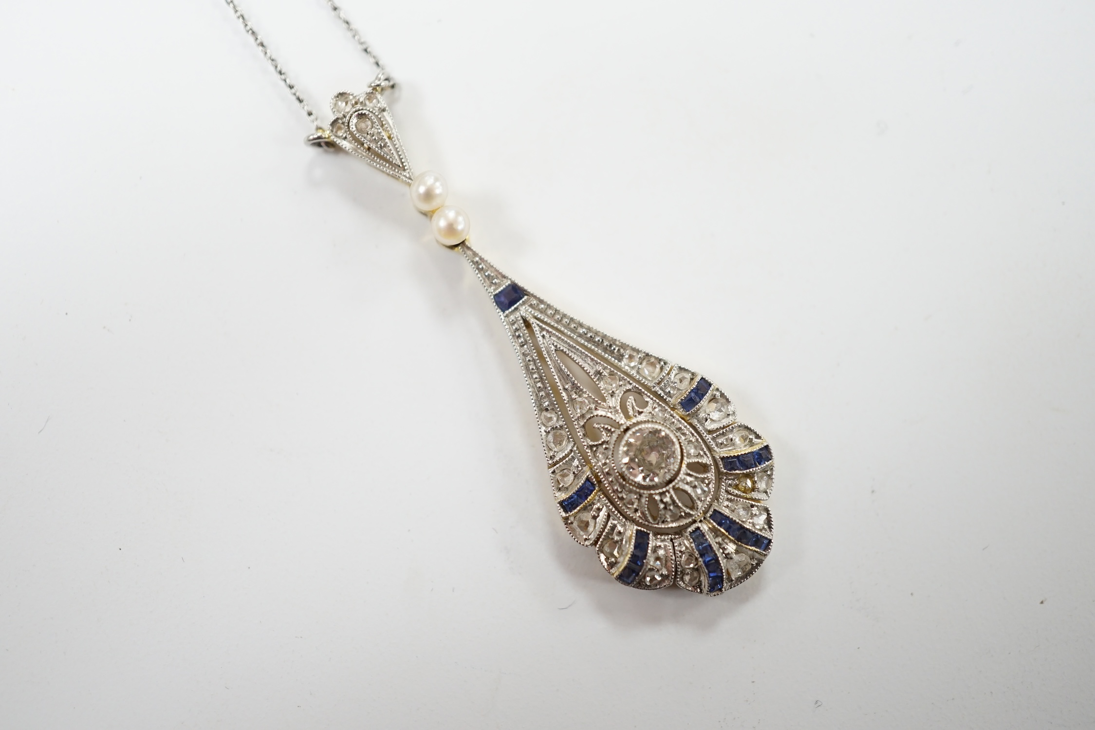 A Belle Époque pierced yellow metal, sapphire, diamond and seed pearl set pendant necklace, overall 50cm, gross weight 4.3 grams. Fair condition.